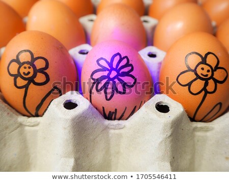 Сток-фото: Pattern Of White And Painted Black Eggs In A Black Cardboard Box On A Blue Background With Copy Spac