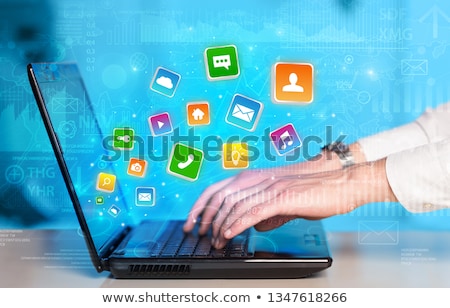 Stock photo: Hand Using Laptop With Bouncing Application Graphs And Report Co