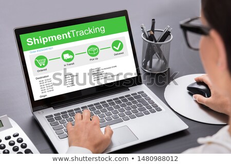 Foto d'archivio: Businesswoman Using Laptop Showing Shipment Tracking Options