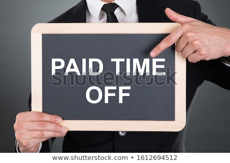 Сток-фото: Business Man Pointing At Paid Time Off Text On Slate