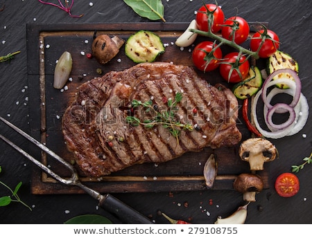 Stok fotoğraf: Delicious Beef Steaks On Wooden Table