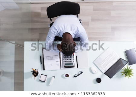 Foto stock: Young Tired Businessman Sleeping At Workplace In Office