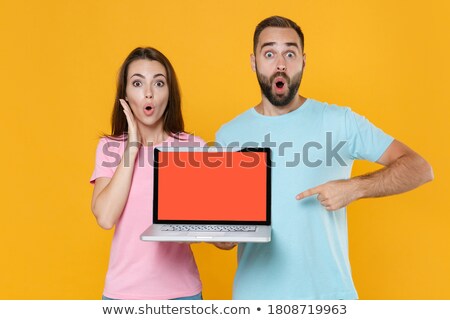 Stok fotoğraf: Portrait Of A Surprised Man Pointing On Blank Screen Laptop