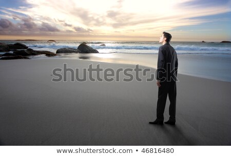 Foto stock: Stones On The Back Of A Man On The Beach