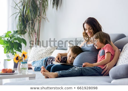 Zdjęcia stock: Pregnant Woman And Boy Reading Book