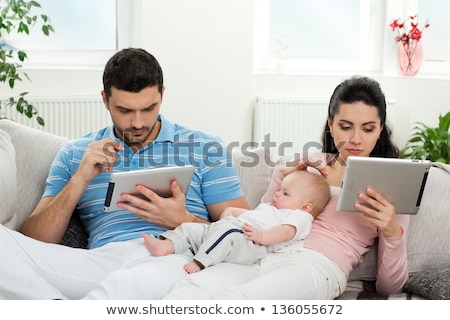 [[stock_photo]]: Mother Father And Baby With Tablet Pc At Home