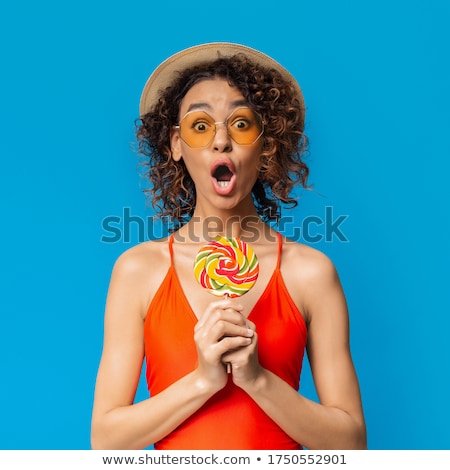 Stok fotoğraf: Pretty Woman In Swimsuit Holding A Candy In The Hands Of