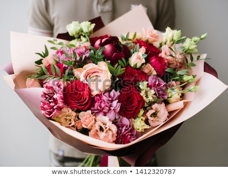 Foto stock: Hands Of Woman Florist Holding Beautiful Bouquet Of Peonies