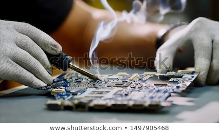 Stock photo: Engineer Or Technician Repair Electronic Circuit Board With Soldering Iron