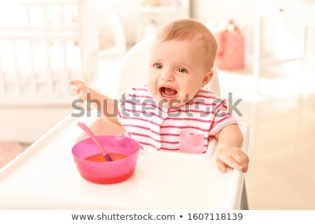Foto stock: Little Baby Girl Crying On A High Chair
