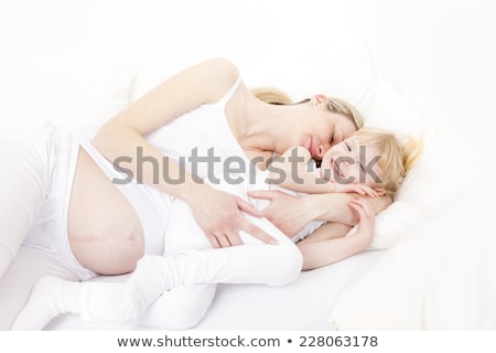 Stock photo: Portrait Of Two Smiling Women Lying Down In White Bed