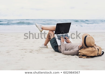 Foto stock: Young Woman With Laptop At The Beach