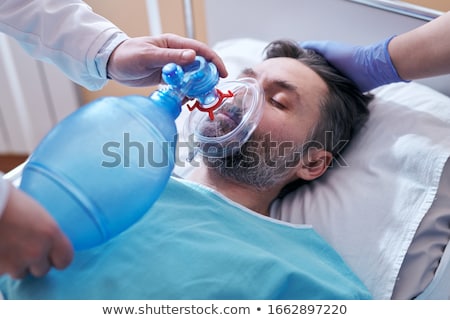 Doctor Placing An Oxygen Mask On The Face Of A Patient Stockfoto © Pressmaster