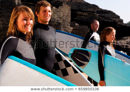 ストックフォト: Four People Standing With Surfboards