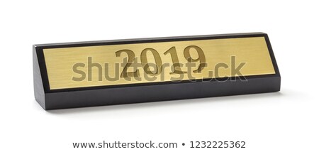 Foto d'archivio: A Name Plate On A White Background With The Engraving 2019