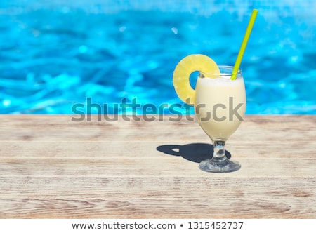 Сток-фото: Glass Of Pinacolada Cocktail Standing On The Swimming Pool Ledge