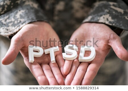 Foto d'archivio: Male Soldier Holding Wooden Cubes With Ptsd Text