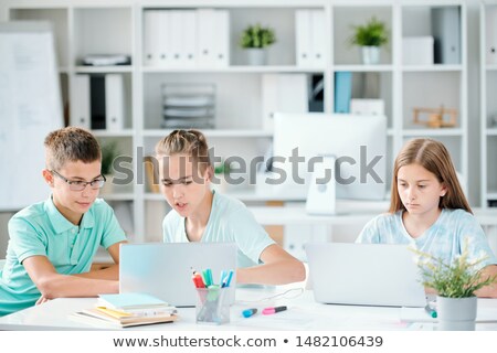 One Of Clever Schoolboys Showing His Classmate Curious Website Foto stock © Pressmaster