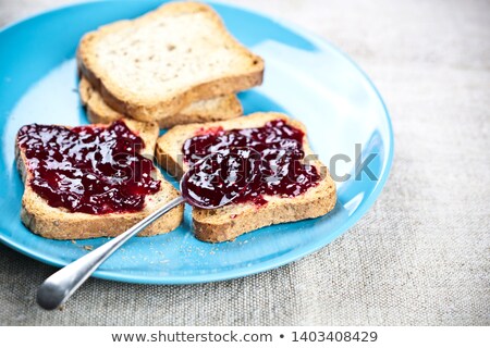 Foto d'archivio: Fresh Toasted Cereal Bread Slices With Homemade Wild Berries Jam