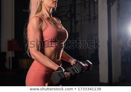 Foto d'archivio: Unrecognizable Woman Posing Dumbbells