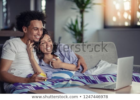 Сток-фото: Young Couple Watching A Movie On Laptop Together
