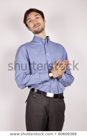 Stok fotoğraf: Happy Sly Man In White Shirt Holding Hands Together