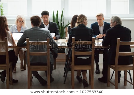 Stok fotoğraf: Businesspeople Preparing Document In Conference Room