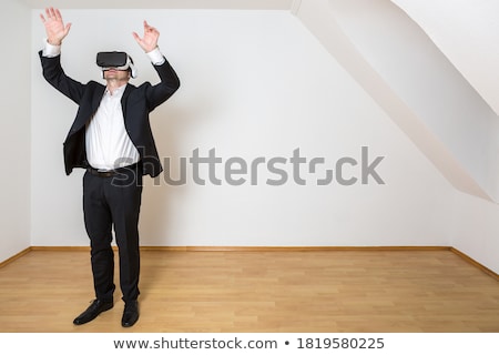 Stockfoto: Businessman In An Empty Room With Vr Glasses