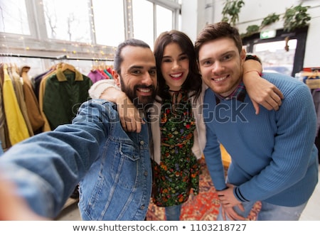 Stok fotoğraf: Friends Taking Selfie At Vintage Clothing Store