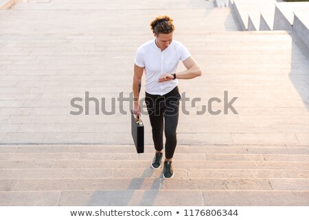 Imagine de stoc: Above View Of Calm Curly Business Man With Briefcase