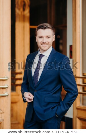 Сток-фото: Attractive Male Executive Manager In Formal Outft Keeps Hand In Pocket Has Positive Expression St