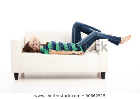 Foto stock: Beautiful Girl Lying On A White Sofa