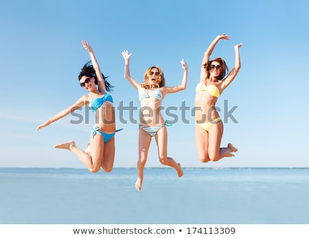 Stockfoto: Woman In Bikini Jumping On The Beach