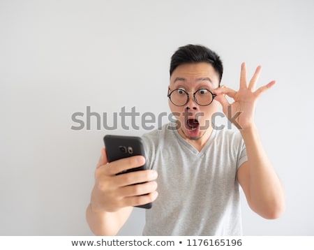 Stockfoto: Young Man Surprised At What He Reads