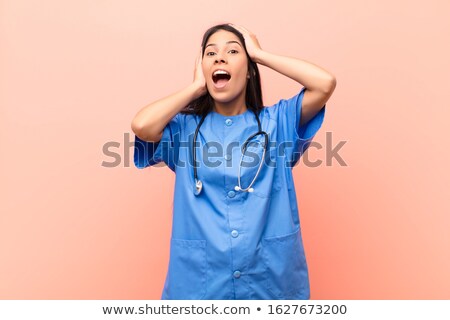 Stock photo: Shocked Young Doctor Surprised Nurse Woman Extremely Excited Dentist Lady Astonished Mid Aged Gi