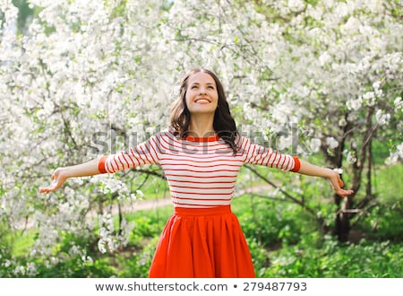 Stockfoto: Young Woman Enjoying A Beautiful Blooming Garden