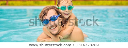 Stok fotoğraf: Dad And Son In Swimming Goggles Have Fun In The Pool Banner Long Format