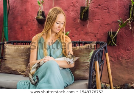 Stock photo: Young Woman Having A Mediterranean Breakfast Seated At Sofa And Drinks Hot Aromatic Coffee
