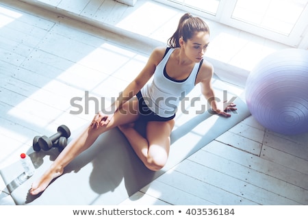 Stock fotó: Floor Exercise With Ball By Beautiful Woman In Gym