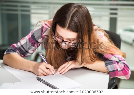 Foto stock: Businesswoman Writing Notes In Folder