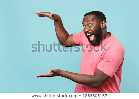 Stockfoto: Excited Young African Man In T Shirt