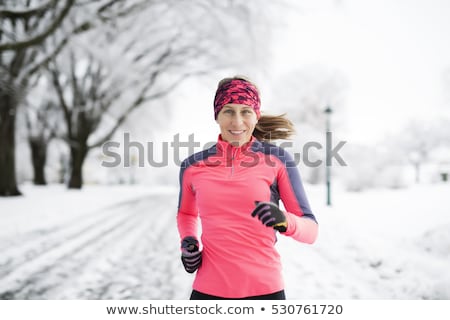 Stock photo: Woman Running In Snowy Park In Winter Season