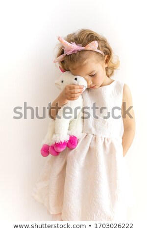 Stockfoto: Portrait Of A Smiling Young Curly Blonde Girl In Dress Playing