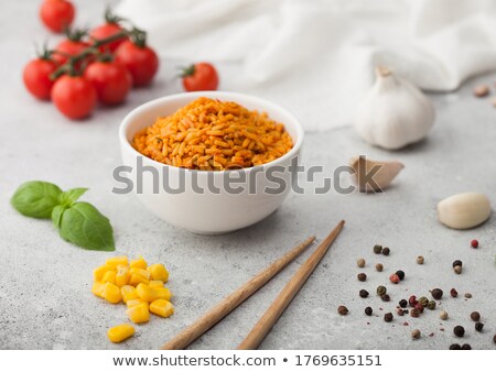 Stok fotoğraf: White Ceramic Bowl Plate With Boiled Red Long Grain Basmati Rice With Vegetables On Light Table Back