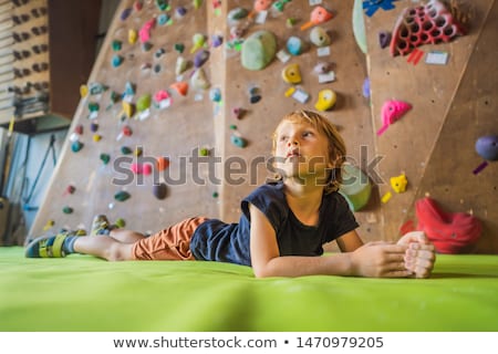 Stock photo: Boy Resting After Climbing A Rock Wall Indoor