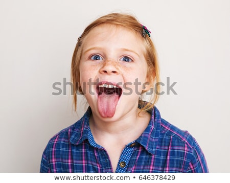 Foto stock: Beautiful Girl In Red Shirt Showing Her Tongue