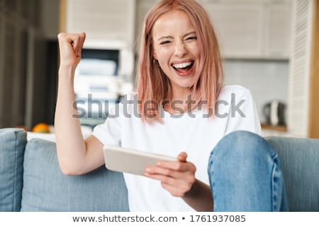 Stock fotó: Image Of Delighted Woman Smiling And Making Winner Gesture