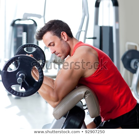 Fitness - Jonge Man Uitoefenen Op Bank Met Gewichten Stockfoto © lunamarina