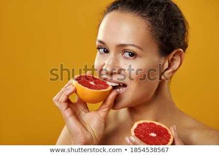 Stock fotó: Young Girl Biting A Juicy Grapefruit