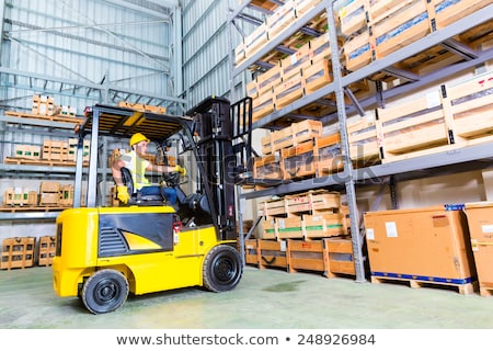 Man Driving Fork Lift Truck In Warehouse Stockfoto © Kzenon